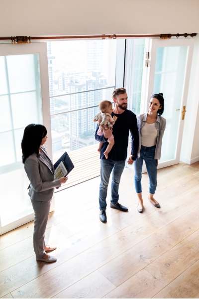 Family with newborn and realtor looking at apartment