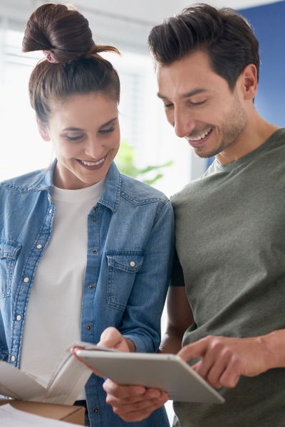 Couple smiling looking over paperwork