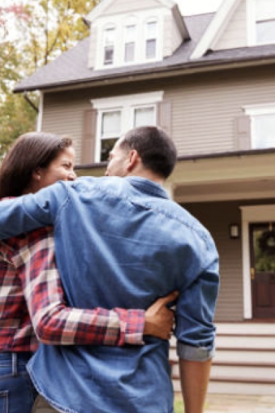 Couple embracing walking toward house