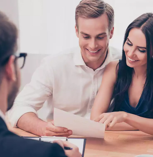 Couple looking over loan in office
