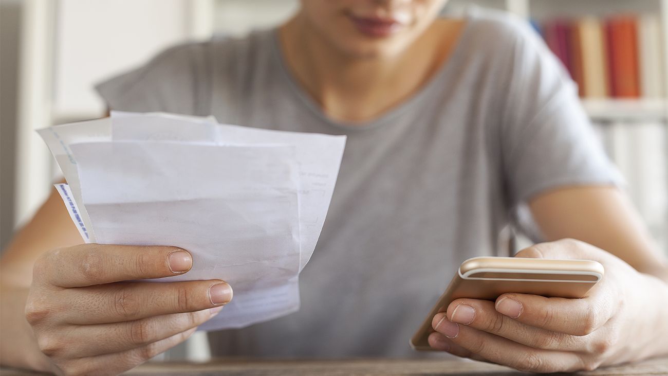 Woman calculating receipts with a phone app