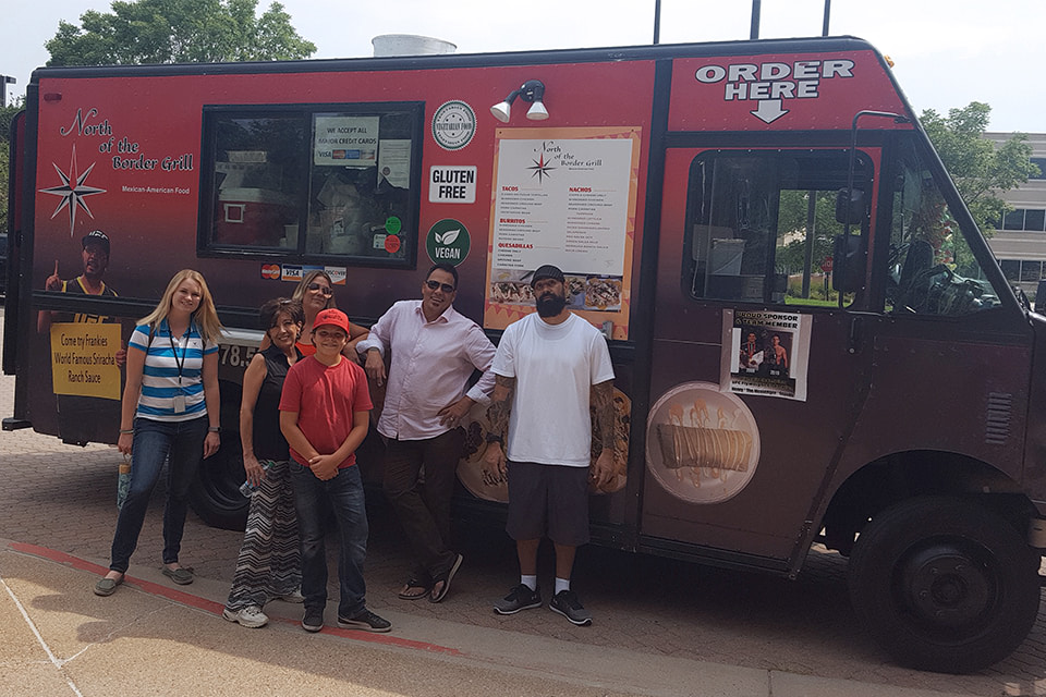 AFC employees standing with a food truck