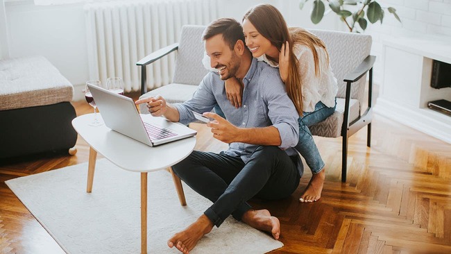 Young couple reviewing finances on a laptop