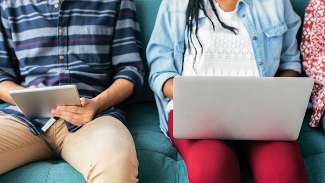 Two people researching loan options