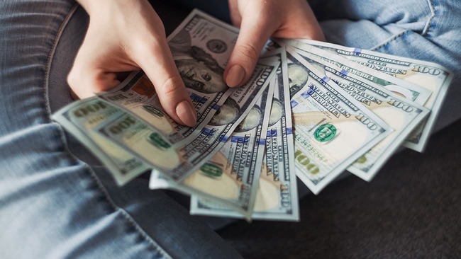 Person showing $100 bills