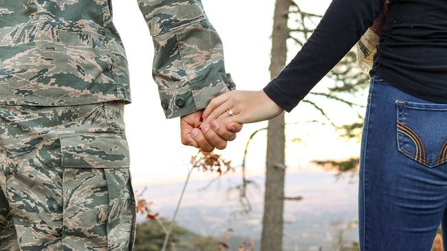 Veteran holding hands with wife