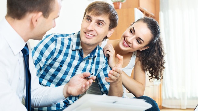 Happy couple closing on a home refinance