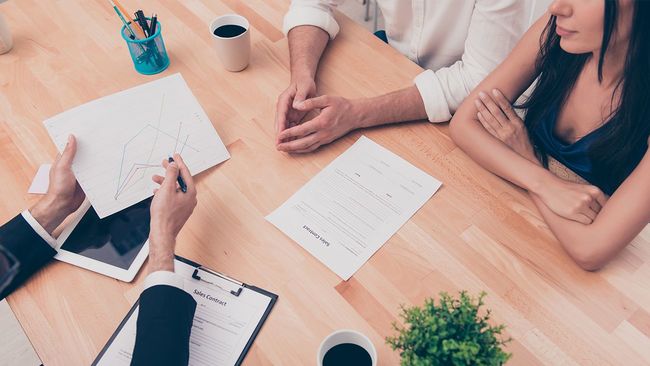 Couple meeting with mortgage closing agent
