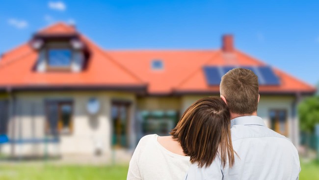 Couple looking at house in daytime