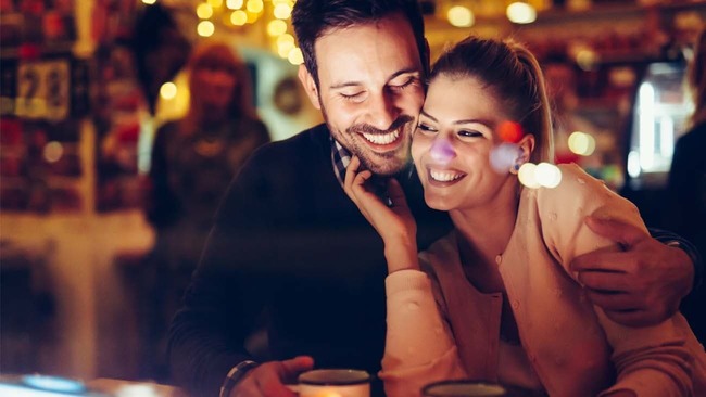 Happy couple enjoying date night at bar