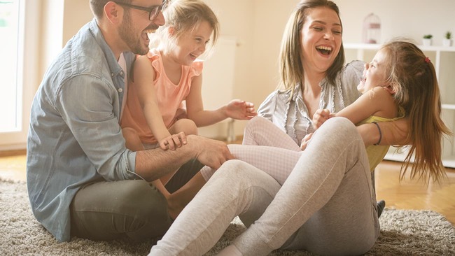Happy family laughing and playing at home