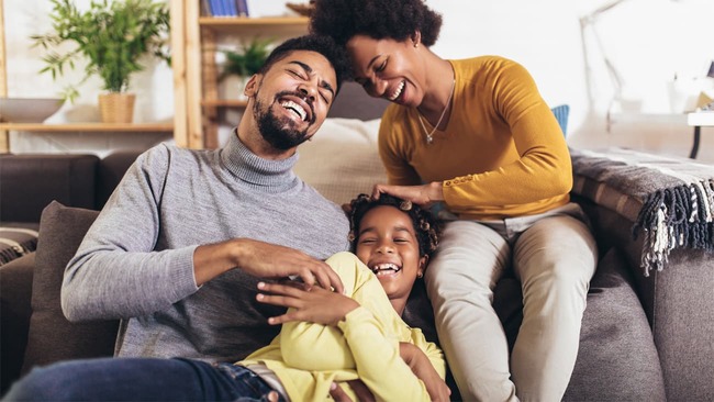 Happy family playing in living room