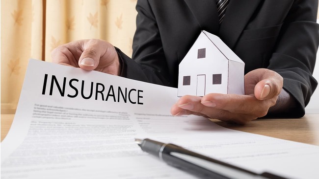An agent showing a homeowners insurance policy