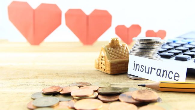 Home insurance card next to budgeting tools