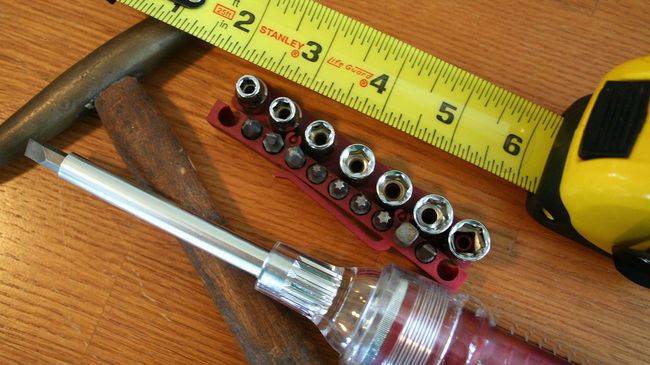 Home maintenance tools on a wood floor
