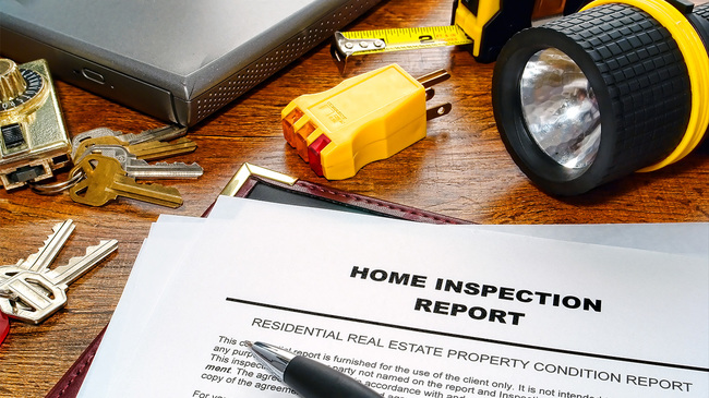 Home inspection report with keys and flashlight