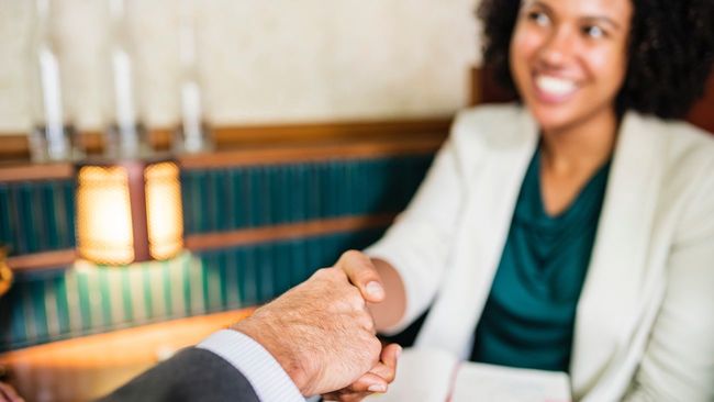 Homebuyer and seller shaking hands.