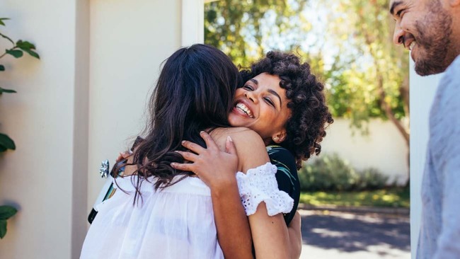 Couple welcoming friend for party