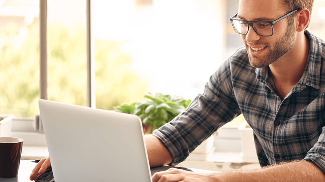 Man searching home loan options on a computer.