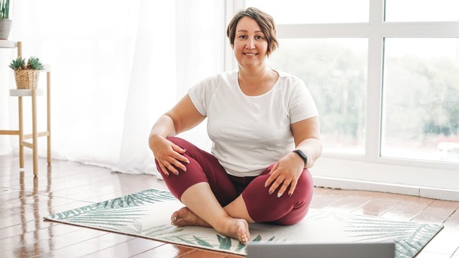 Woman on yoga mat at home