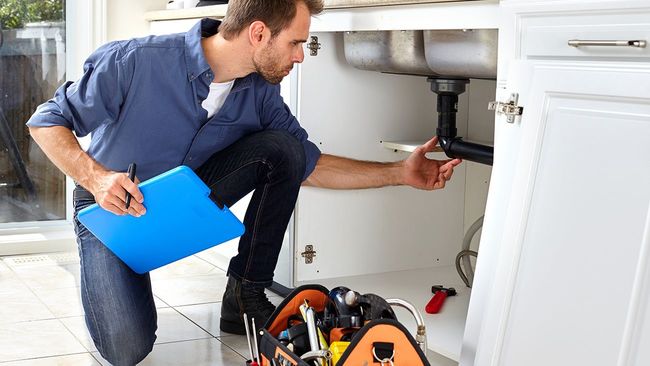 Man performing a home inspection for a buyer