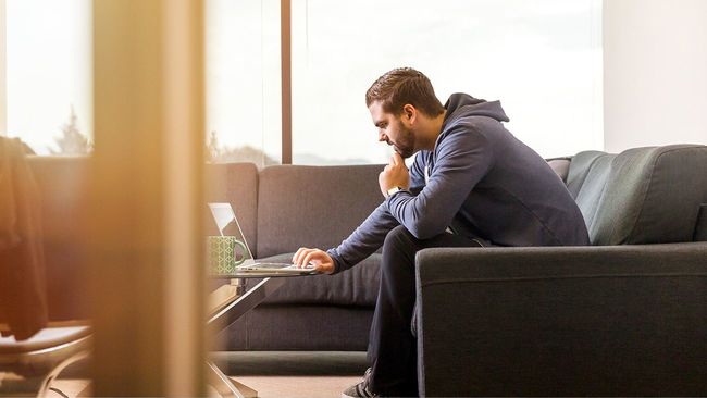 Man researching mortgage assistance on home laptop