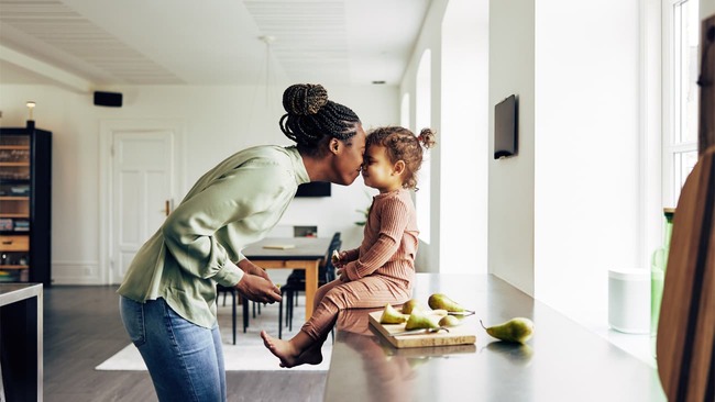 Mom and baby touching noses in kitchen