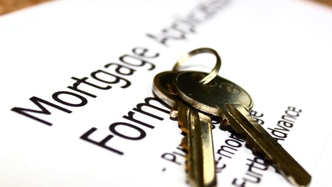 House keys lying on top of a mortgage application form