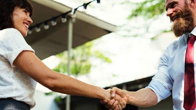 Mortgage lender shaking hands with broker