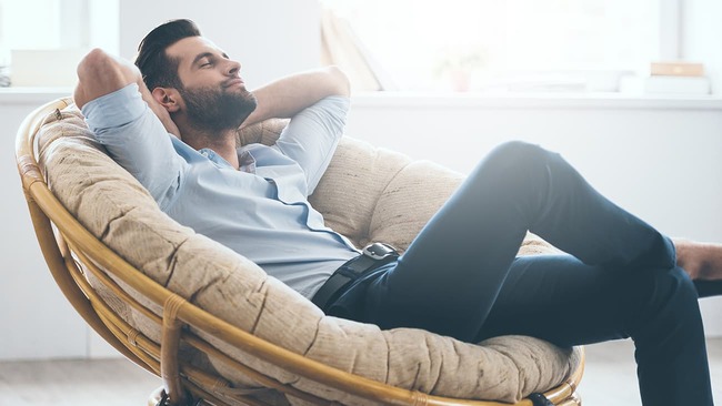 Man relaxing in comfortable chair at home