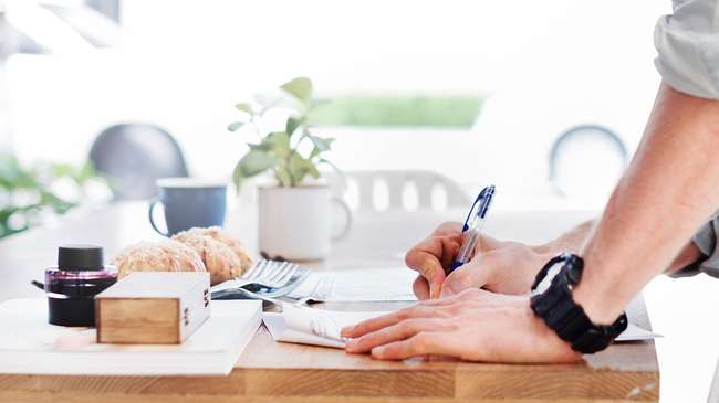 Man signing mortgage refinance paperwork