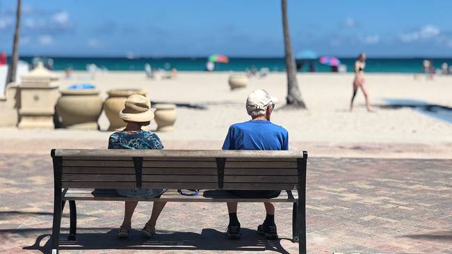 Retired couple sitting on a bench