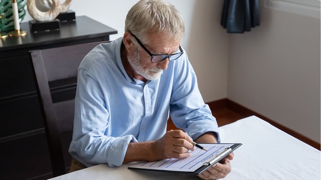 Senior man looking over reverse mortgage application