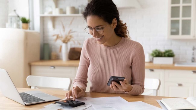 Woman preparing her taxes in kitchen