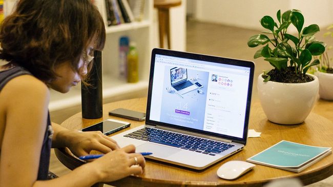 Self-employed woman working from home laptop