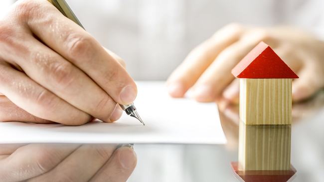 Homeowner signing mortgage documents 