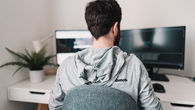 Man working from home on two screens