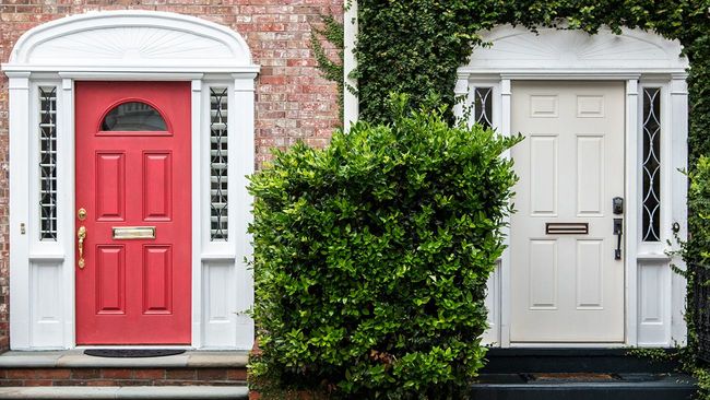 Two side by side entry doors to brick townhomes