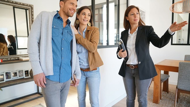 Couple at home showing with agent