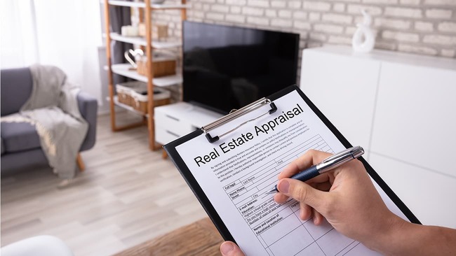 Filling out a home appraisal in living room