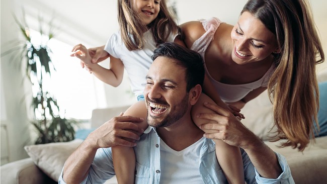 Young family having fun in living room