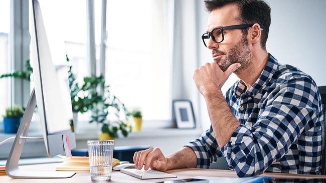 Man focusing on computer in office