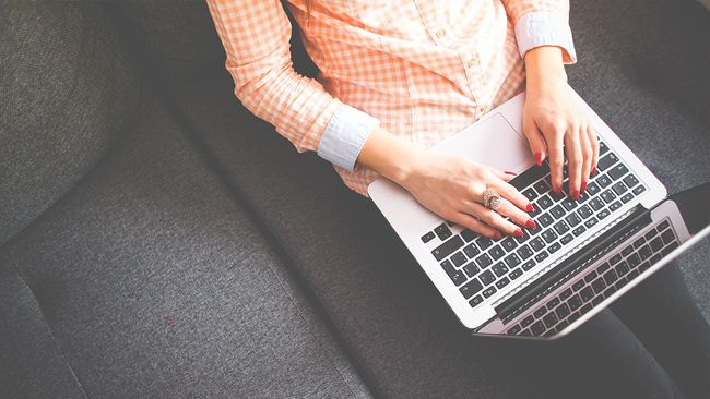 Woman electronically signing documents on laptop