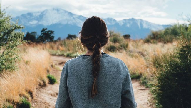 Woman looking at Colorado mountain landscape