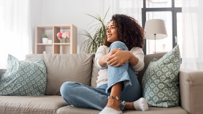 Woman relaxing on couch at home