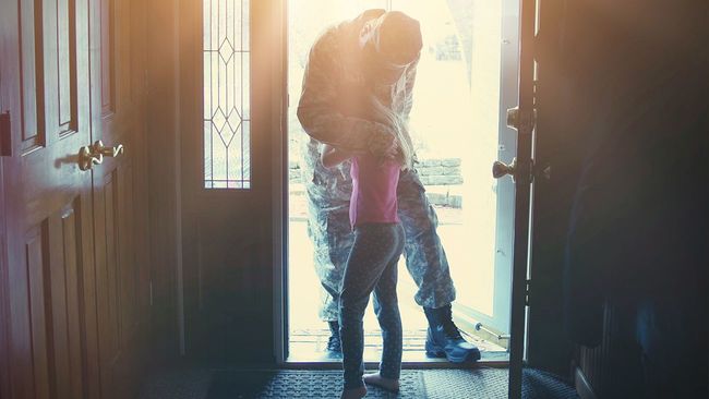 Soldier hugging daughter after arriving home