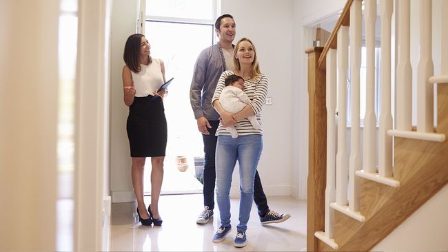 Real estate agent showing young family a new home